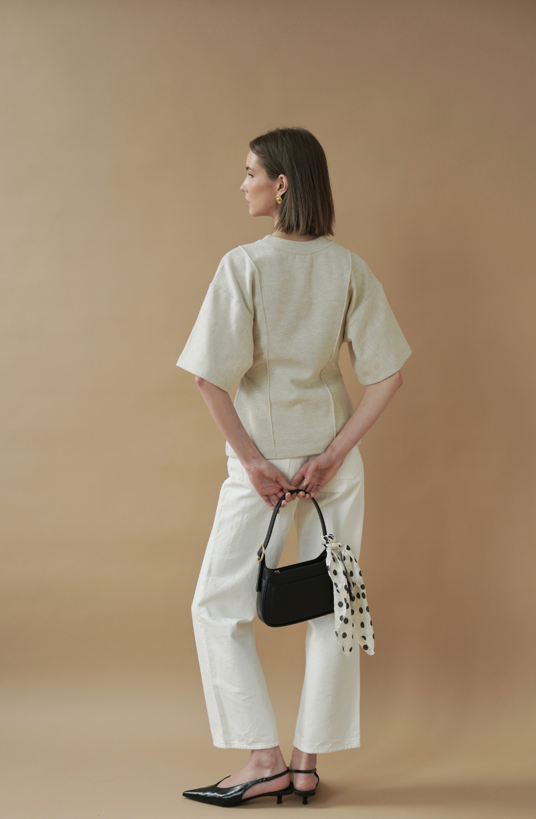 black shoulder bag with gold buckle detail, a refined option for everyday styling