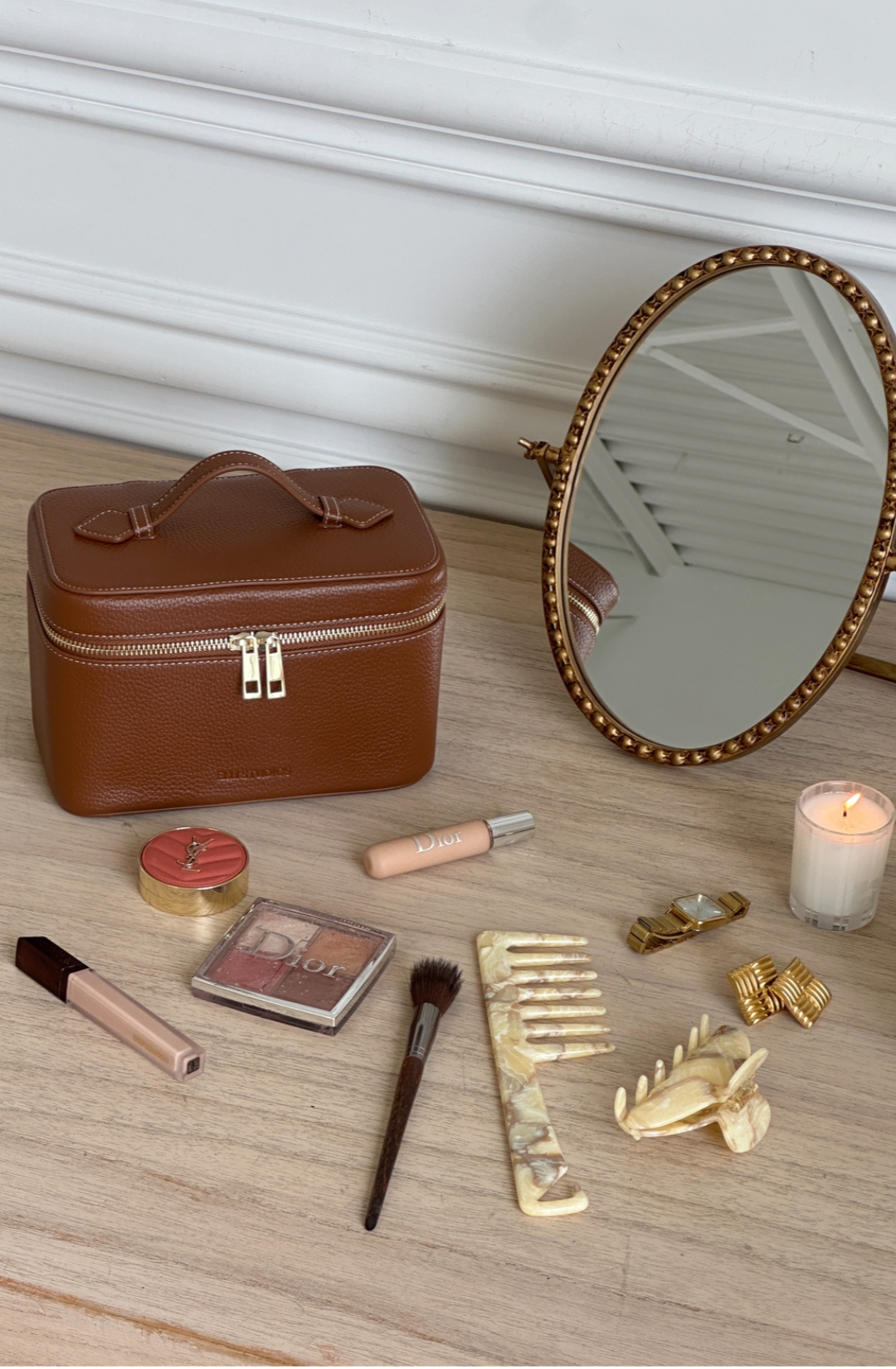 Structured brown vanity case styled with beauty products on a chic vanity table