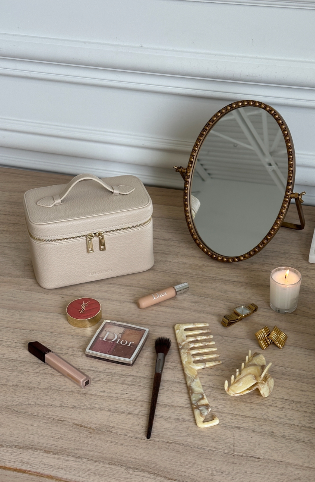 Minimal cream vanity case styled with beauty essentials in a clean setting