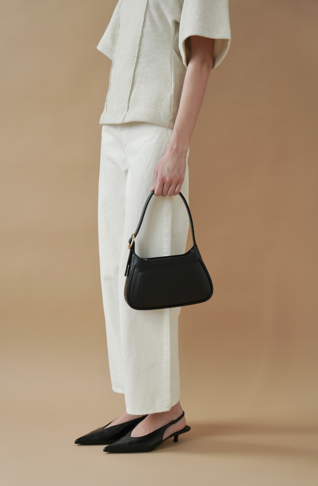 elevated black shoulder bag with gold buckle detail, perfect for evening and occasion wear